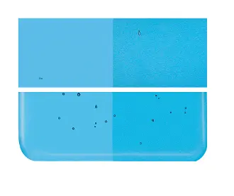 A picture of a 1116-0030 Turquoise Blue Transparent tile with a black spot in the middle.
