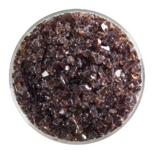 Glass bowl filled with dark purple crystals.