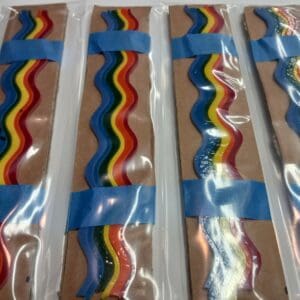 Rainbow-colored ribbon candy in clear packaging.