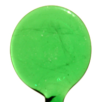 A green plastic spoon on a white background.