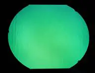 A green Aqua on Clear 4''x4'' light in a circle on a black background.