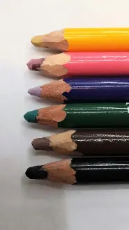 Five Pencil Colors: Black are lined up on a white surface.