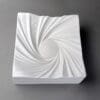 White decorative plate with swirling design.