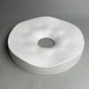 White circular object with a center hole.