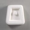 White geometric object with a recessed area.