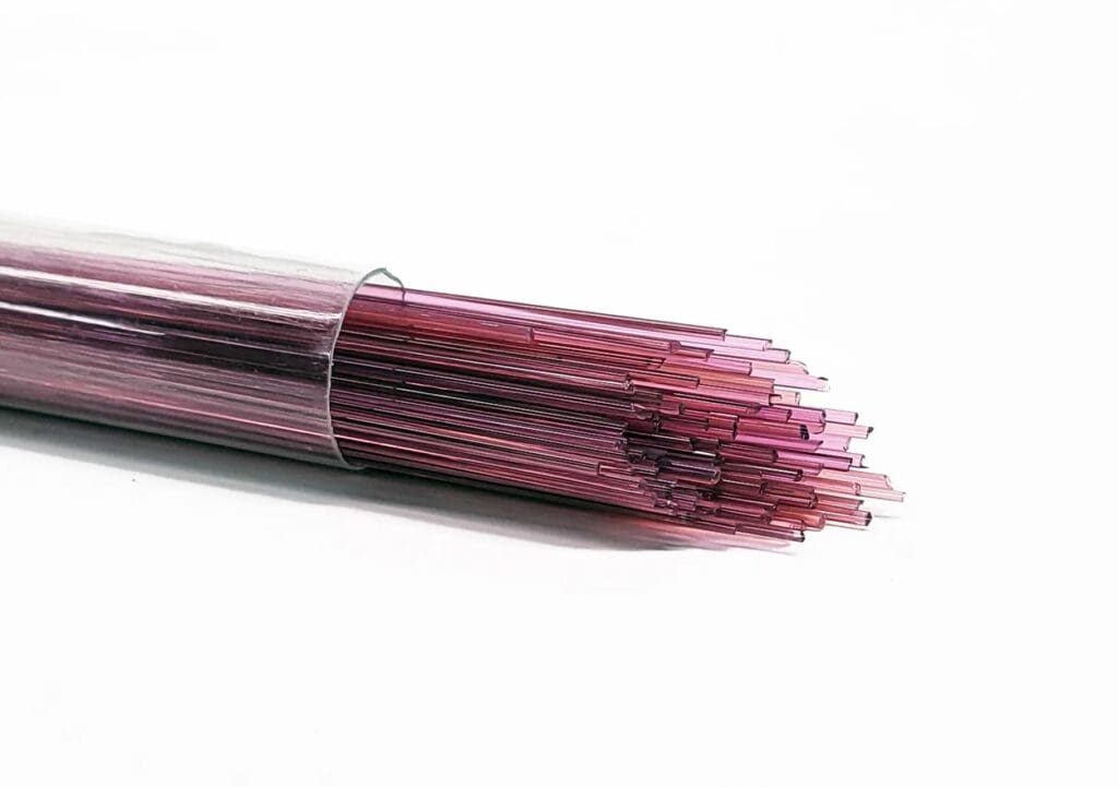Pink glass rods in a transparent tube.